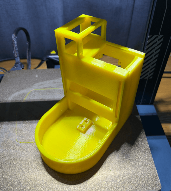 Yellow 3D printed main body of the Soda Can Prevention Device