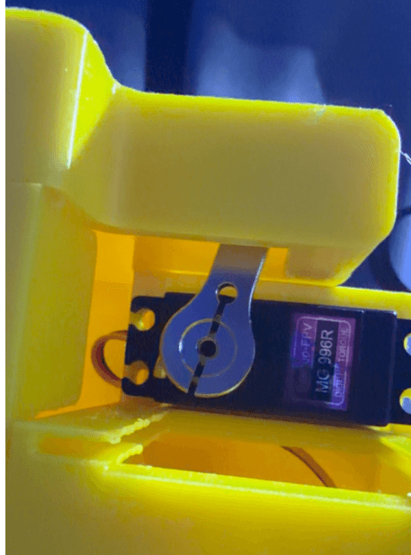 Close-up of the servo locking mechanism inside the yellow printed case