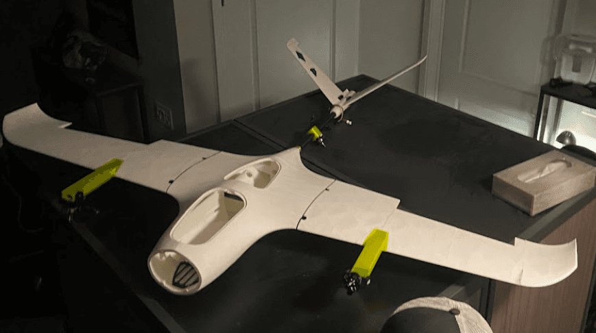 VTOL drone build session table with tools, components, and airframe parts